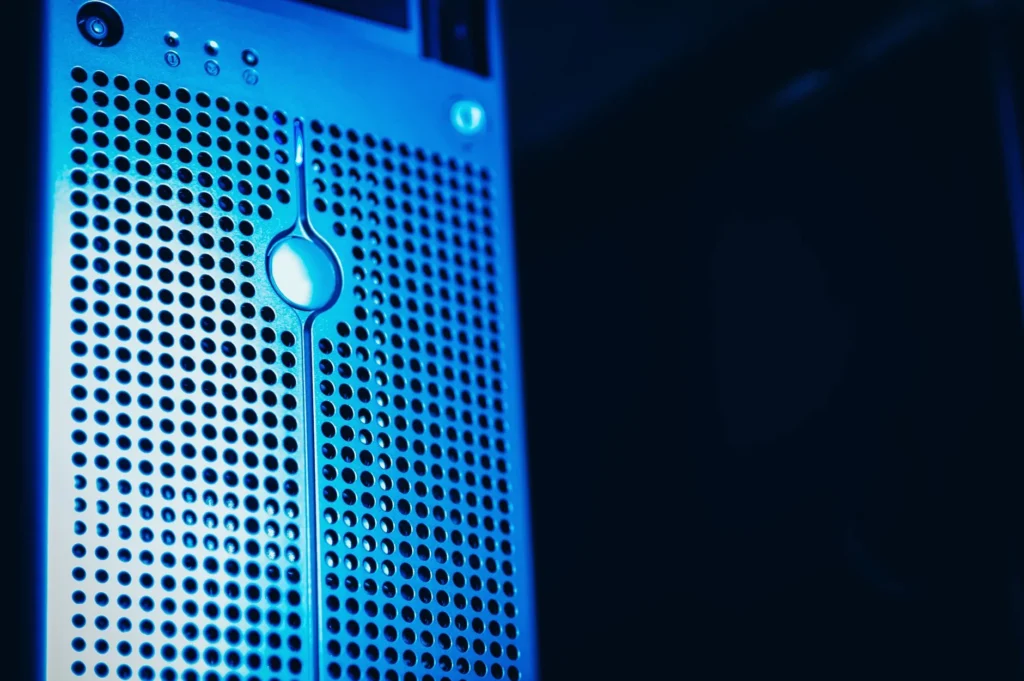 A close-up of a server or computer tower with blue lighting.