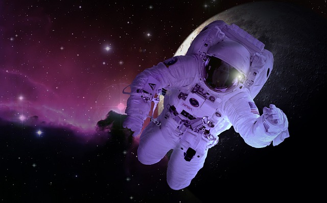 An astronaut floating in outer space near a moon and nebula