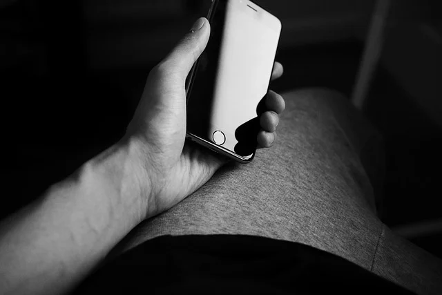 A person holding a smartphone, suggesting mobile app interaction.
