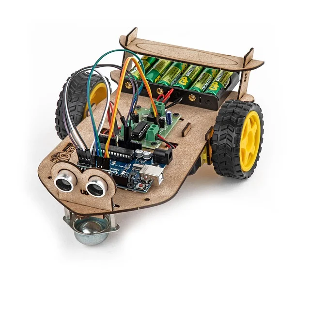 A small, DIY robot car with circuit boards, wires, and batteries.