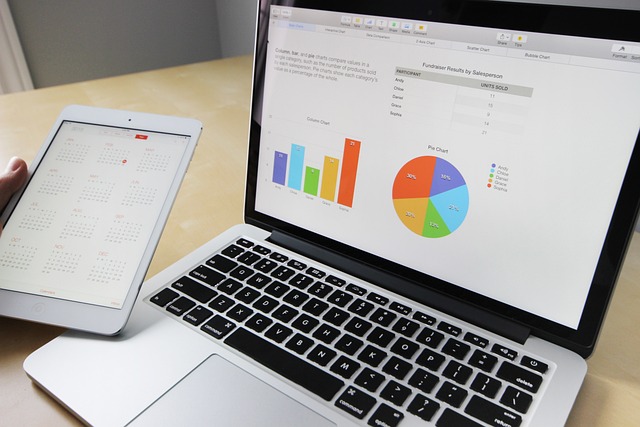 A laptop displaying data charts next to a tablet with a calendar