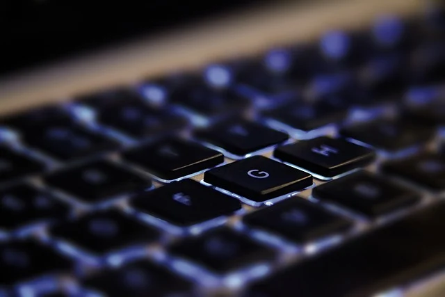 Close-up of a backlit keyboard, highlighting the 'G' key.