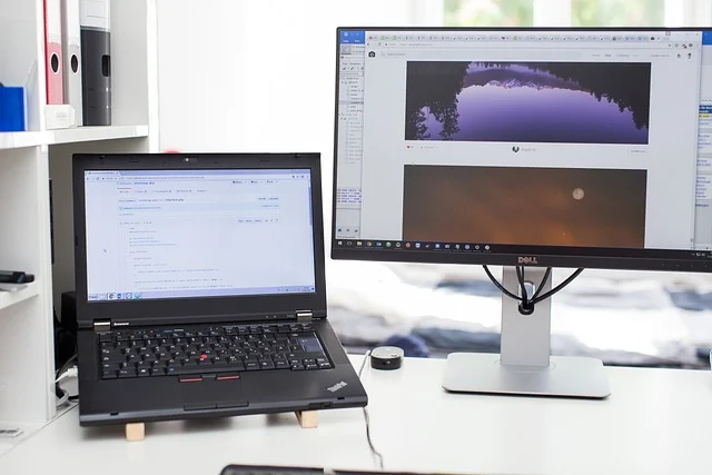 A laptop and an external monitor set up for dual-screen use.