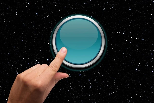 A finger pressing a blue button against a starry background.