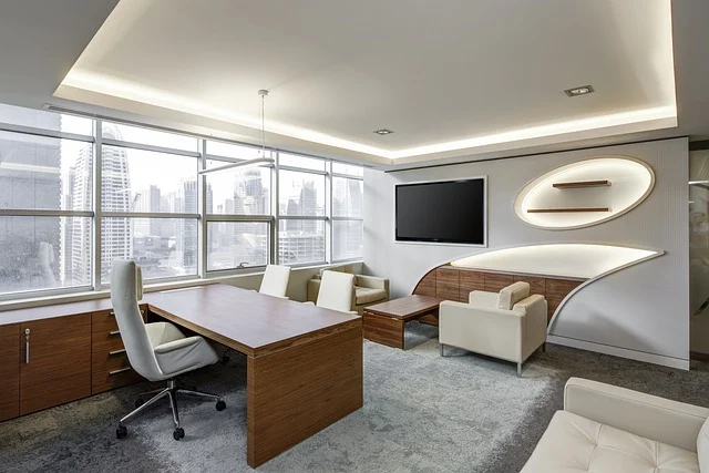 Modern office interior with a desk, chairs, and city view