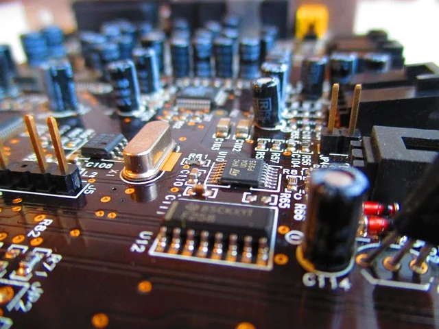 A close-up of an electronic circuit board with microchips and capacitors
