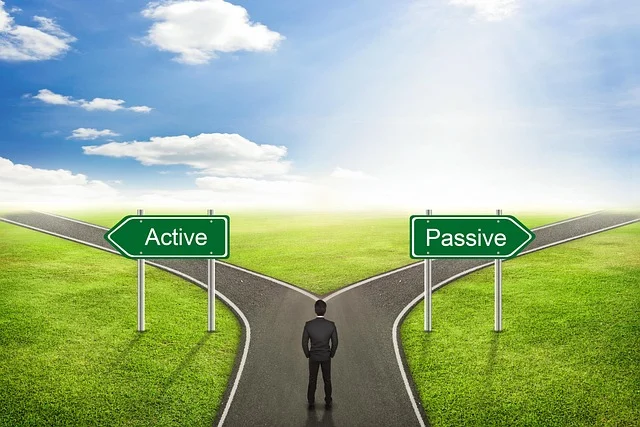Man at a crossroads with signs for 'Active' and 'Passive' paths.