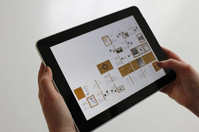 A person holding a tablet displaying multiple documents or app screens.
