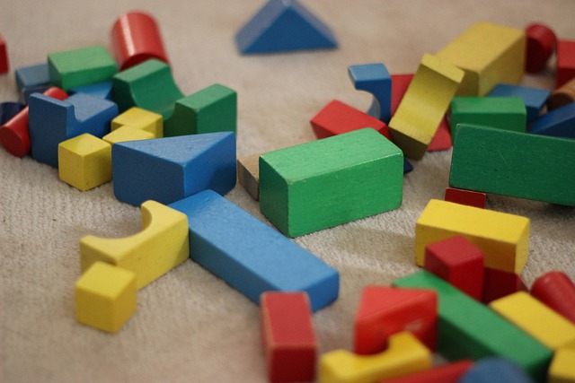 Colorful wooden building blocks scattered on a surface