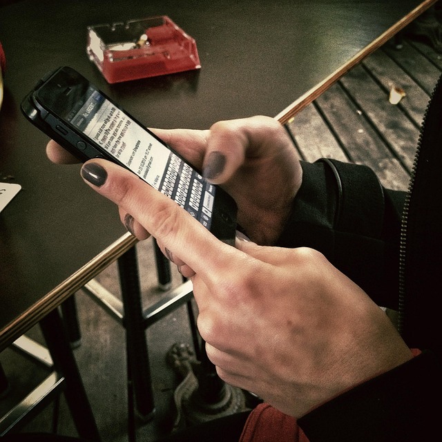 Hands holding and typing on a smartphone