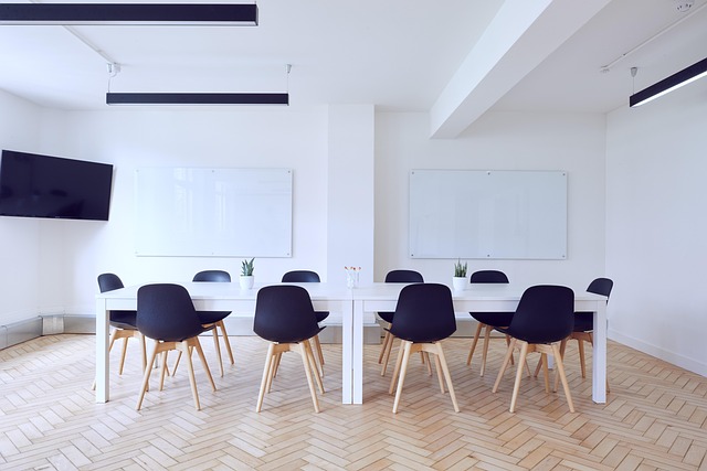 An empty modern conference room with a long table and chairs