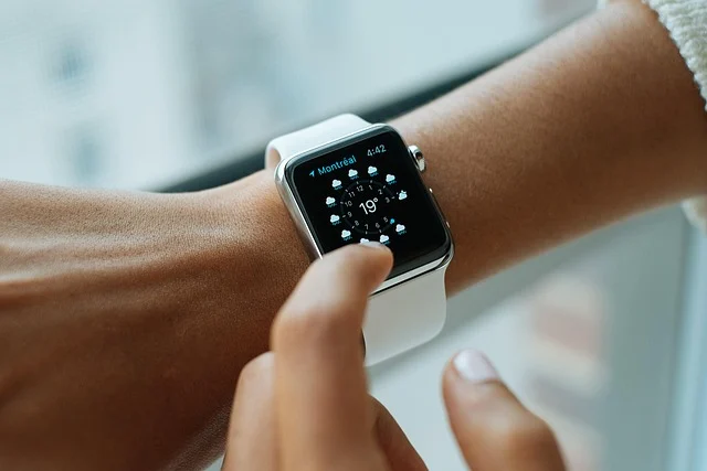 A person interacting with a smartwatch displaying weather information.