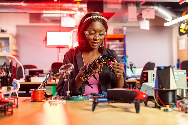 A woman working on robotics and electronics in a laboratory