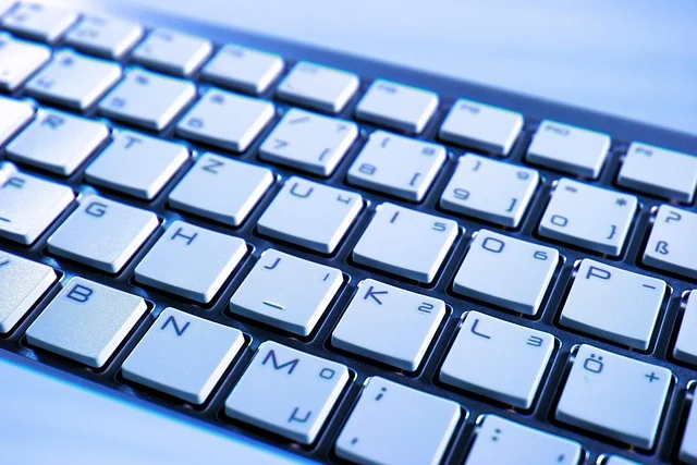 Close-up of a computer keyboard with white keys.