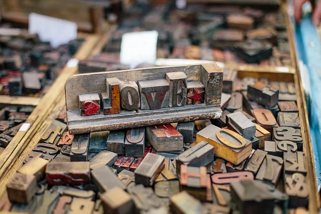 Vintage wooden letterpress blocks spelling 'LOVE' among other type blocks.