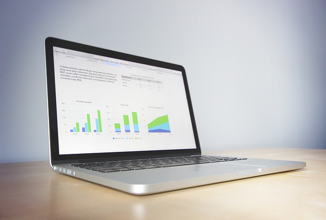A laptop displaying data analytics charts on a desk
