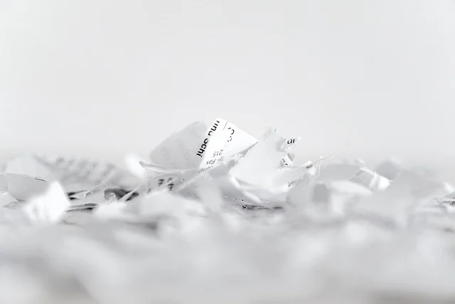Shredded pieces of paper scattered on a white surface