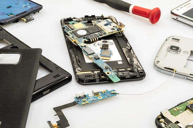 Disassembled smartphone components and circuit boards with repair tools