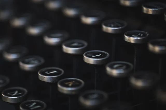 Close-up of vintage typewriter keys, dark and metallic.