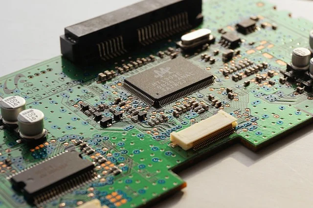 A close-up of a green circuit board with various electronic components
