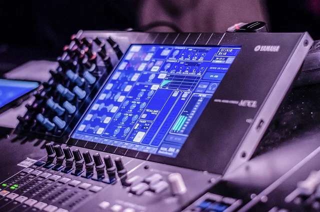 A digital audio mixer with a screen displaying equalizer settings.