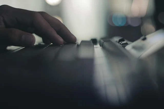 A hand typing on a computer keyboard