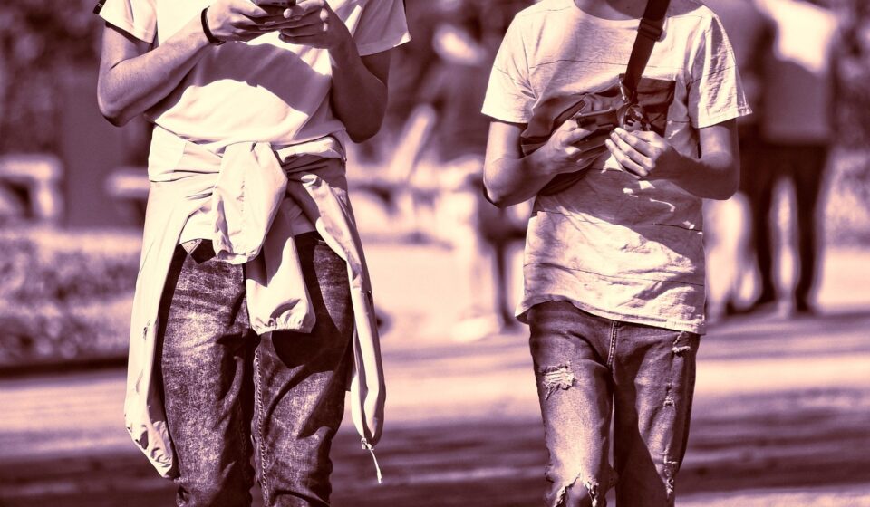 person holding two phones
