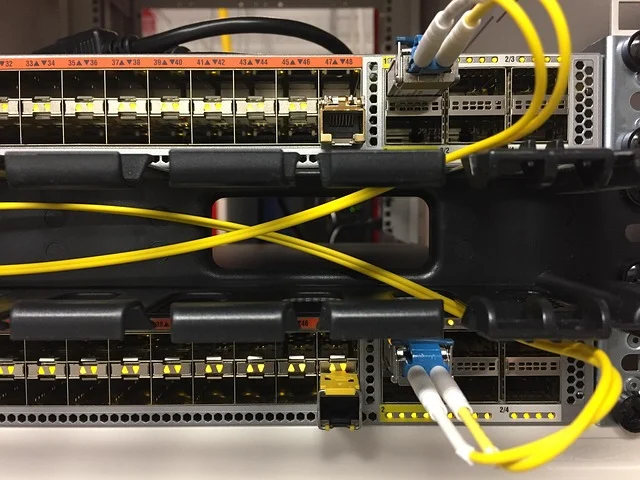 Network switches with fiber optic cables connected in a rack