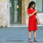 confused person looking at phone