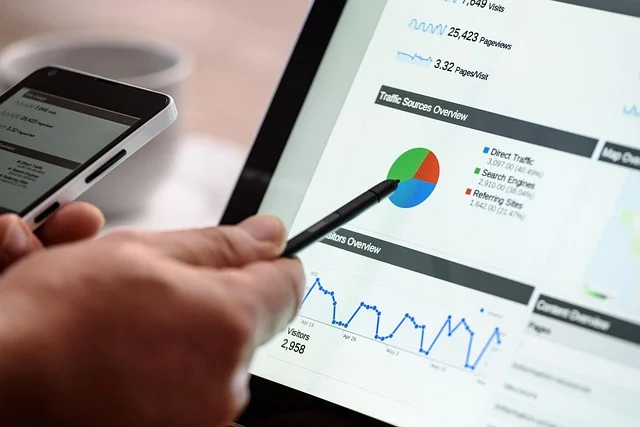 Digital advertising news: Person using a stylus to analyze web traffic data on tablet