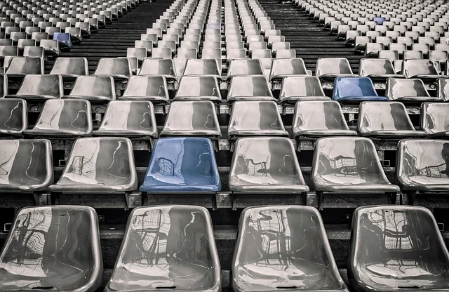 Empty stadium seats, with a few blue ones highlighted