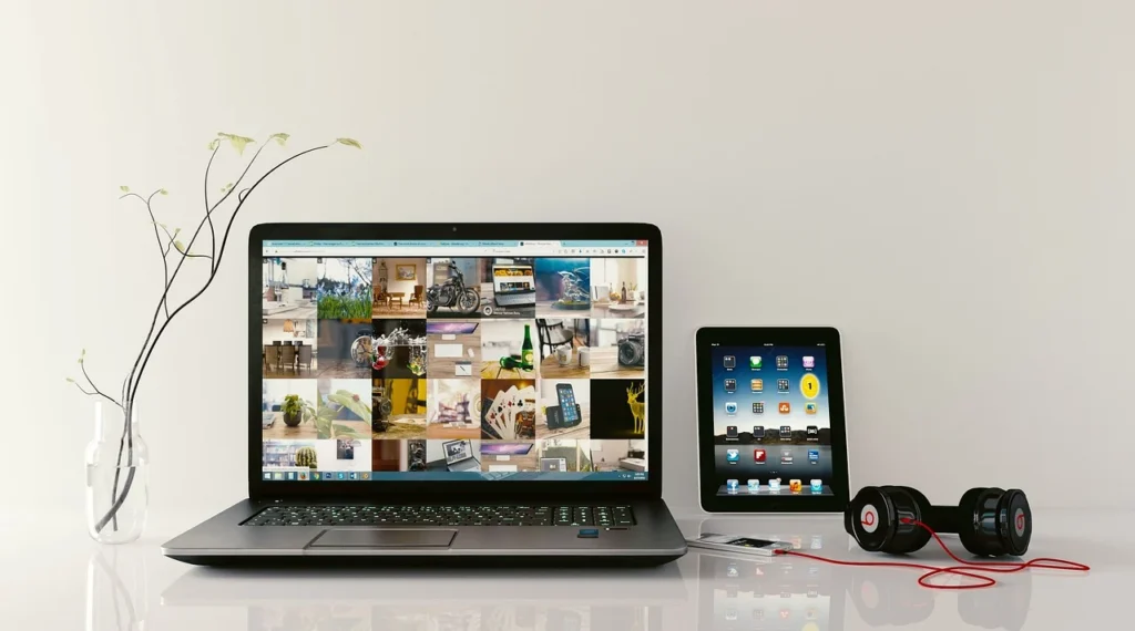 Laptop displaying the Allysplay.com website with various article headlines