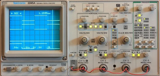 A Tektronix oscilloscope displaying digital signal waveforms on its CRT screen