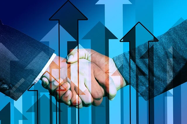 Two people shaking hands with upward arrows in the background.