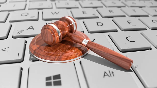 Gmail class action lawsuit: A judge's gavel resting on a computer keyboard, symbolizing online law.
