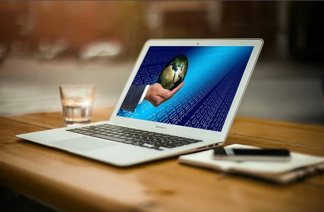 Www.aka.ms.phonelink: A laptop displaying a hand holding a globe with 'FUTURE' text in the background.