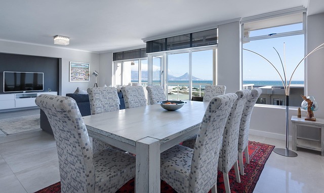 A modern dining area with a large table and ocean view