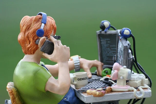 A figurine of a programmer working at a computer desk
