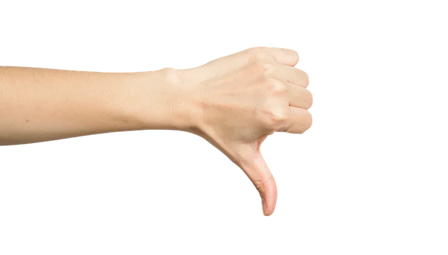 A hand giving a thumbs down gesture, indicating disapproval or unsuitability.